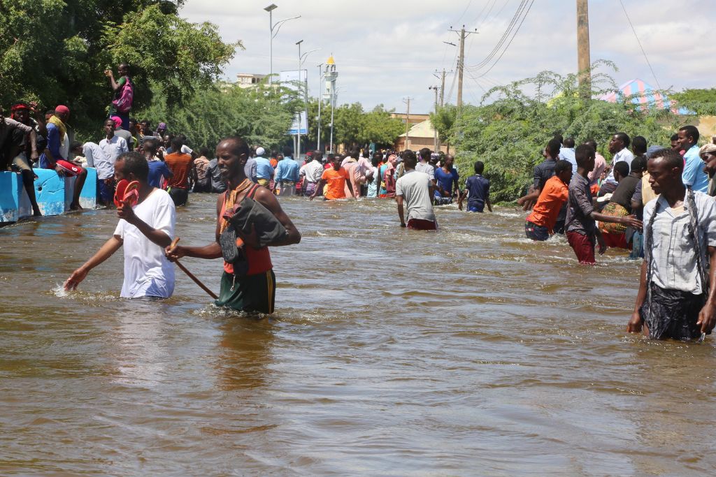 floods horn of africa; People wade through floods that submerged their neighborhood in Belet Weyne, Somalia, on 28 October 2019. UN Photo