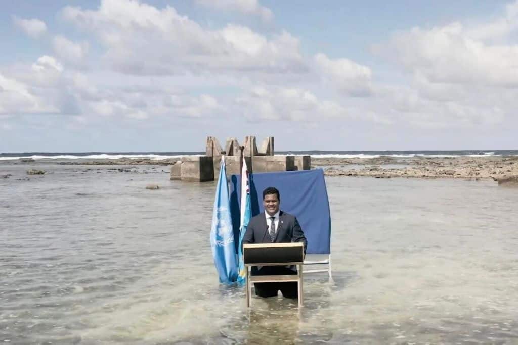 Tuvalu's Foreign Minister's historic speech at the 2021 United Nations COP26 became a symbol of Tuvalu and other small island nations’ sinking fate. Credit: Ministry of Justice, Communication and Foreign Affairs, Tuvalu Government (Facebook Video – Screenshot)