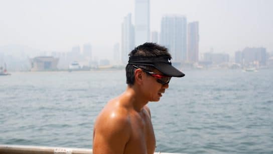 A man running on the waterfront of Hong Kong Island on a hot summer day.