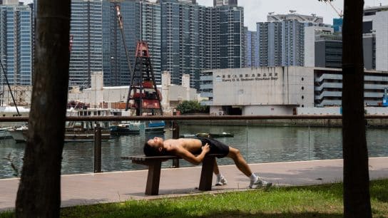 A runner resting on a bench in Hong Kong in June 2024.