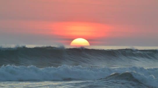 An orange sunset over the ocean.