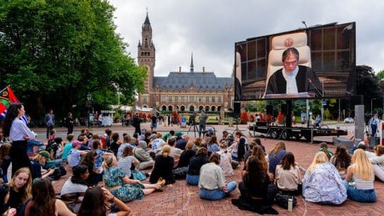 People watch the live stream of the ICJ advisory opinion delivery outside of the Peace Palace in The Hague on July 23, 2025.