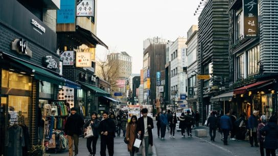 People walking on a shopping street in Seoul, South Korea.