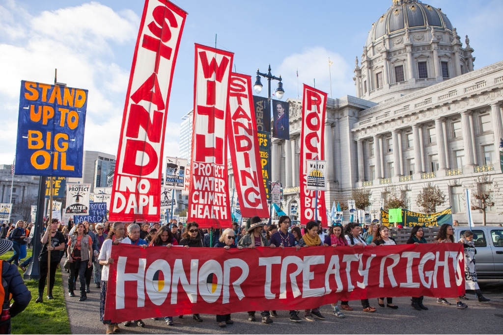People protesting the Dakota Access Pipeline march past San Francisco City Hall.