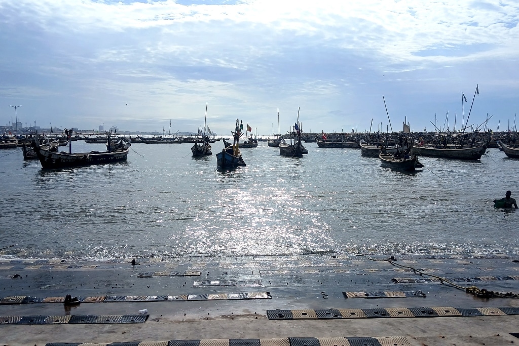 Fishing boats rest on calm water at Jamestown harbour.