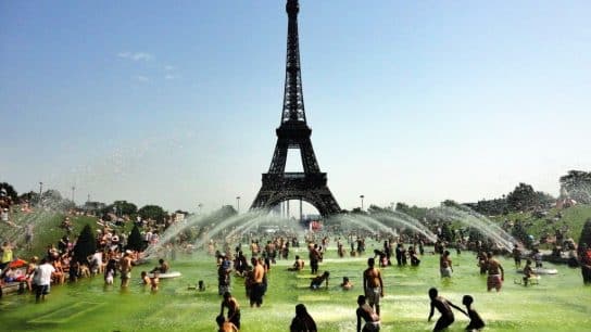Parisians beat the heat by playing in the fountain in front of the Eiffel Tower.
