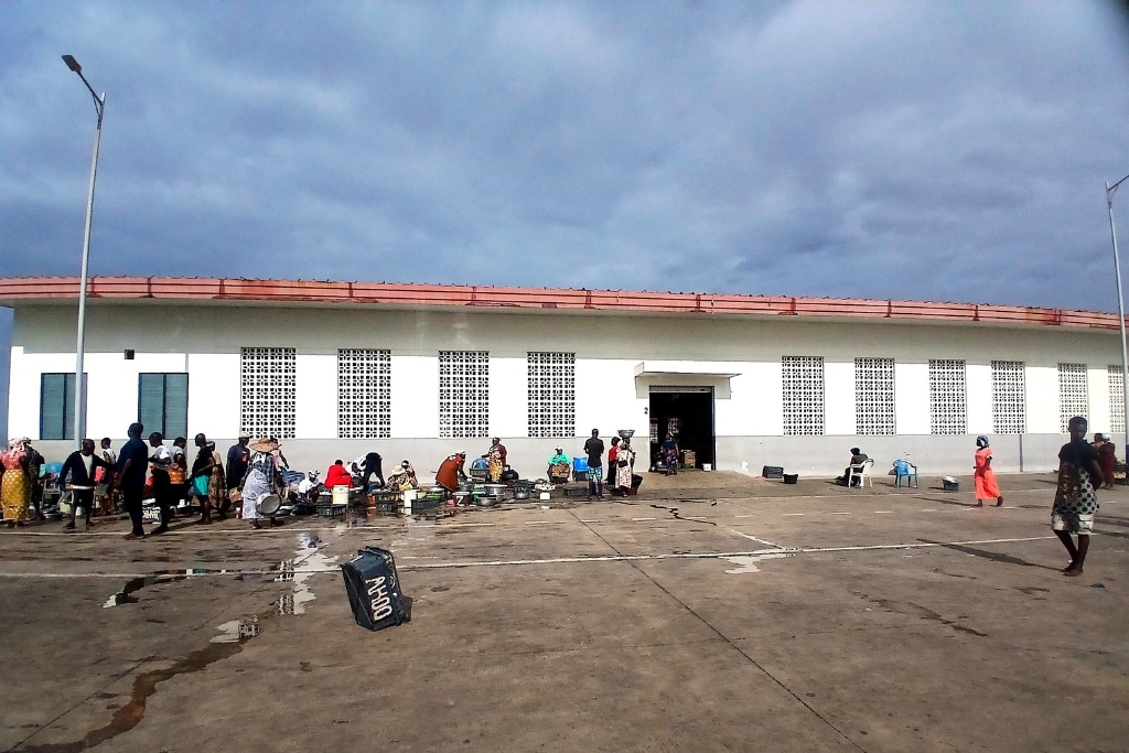 People sit outside the Jamestown Fishing Harbour