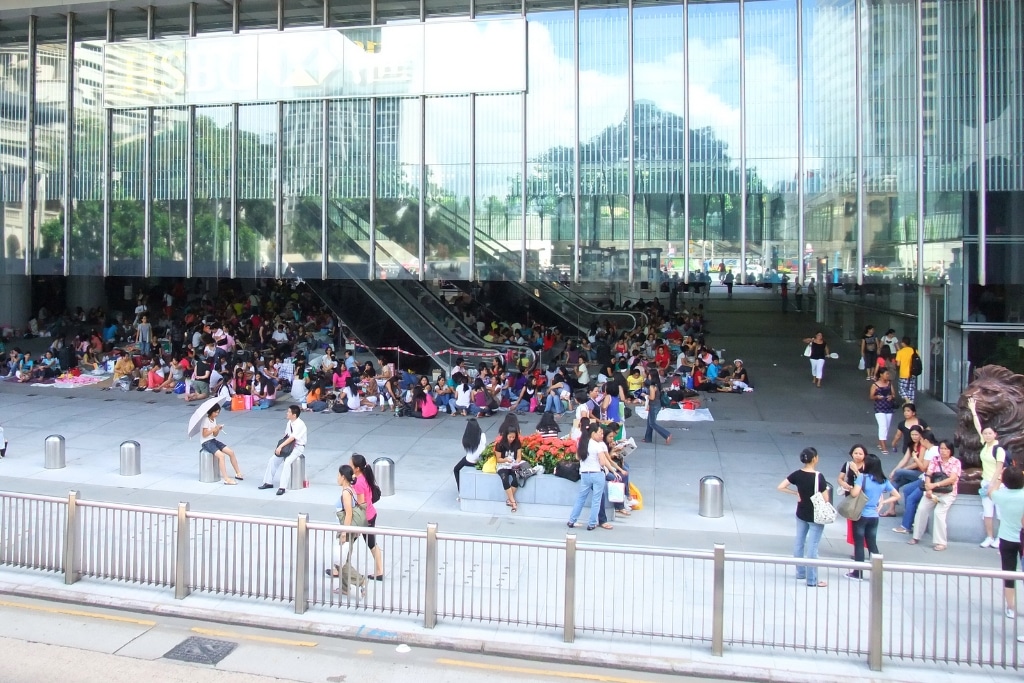 Foreign domestic helpers gather around the HSBC Main Building in Central, Hong Kong, on their rest day.