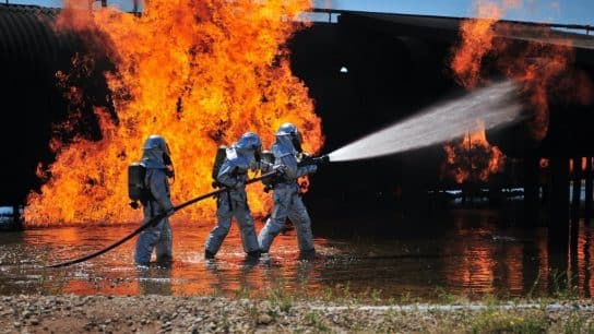Firefighters battle a fire with aqueous film-forming foam (AFFF).