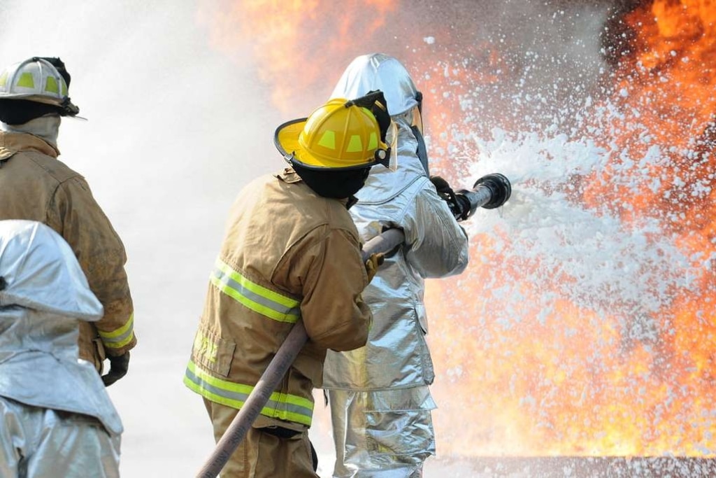 U.S. Air Force and New Jersey state fire protection specialists from the New Jersey Air National Guard's 177th Fighter Wing battle a simulated aircraft fire with Aqueous Film Forming Foam at Military Sealift Command Training Center East in Freehold, N.J.